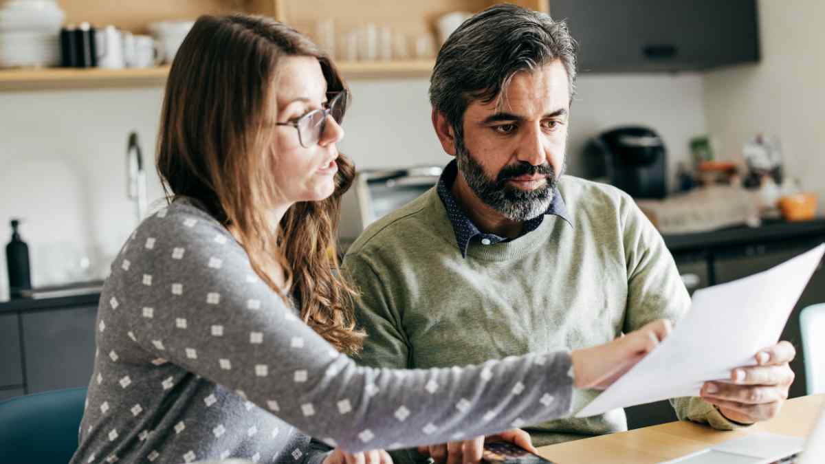 A married couple discussing the requirements for a title loan.