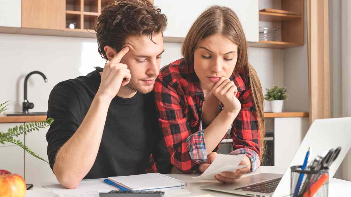 A married couple calculating their loan costs